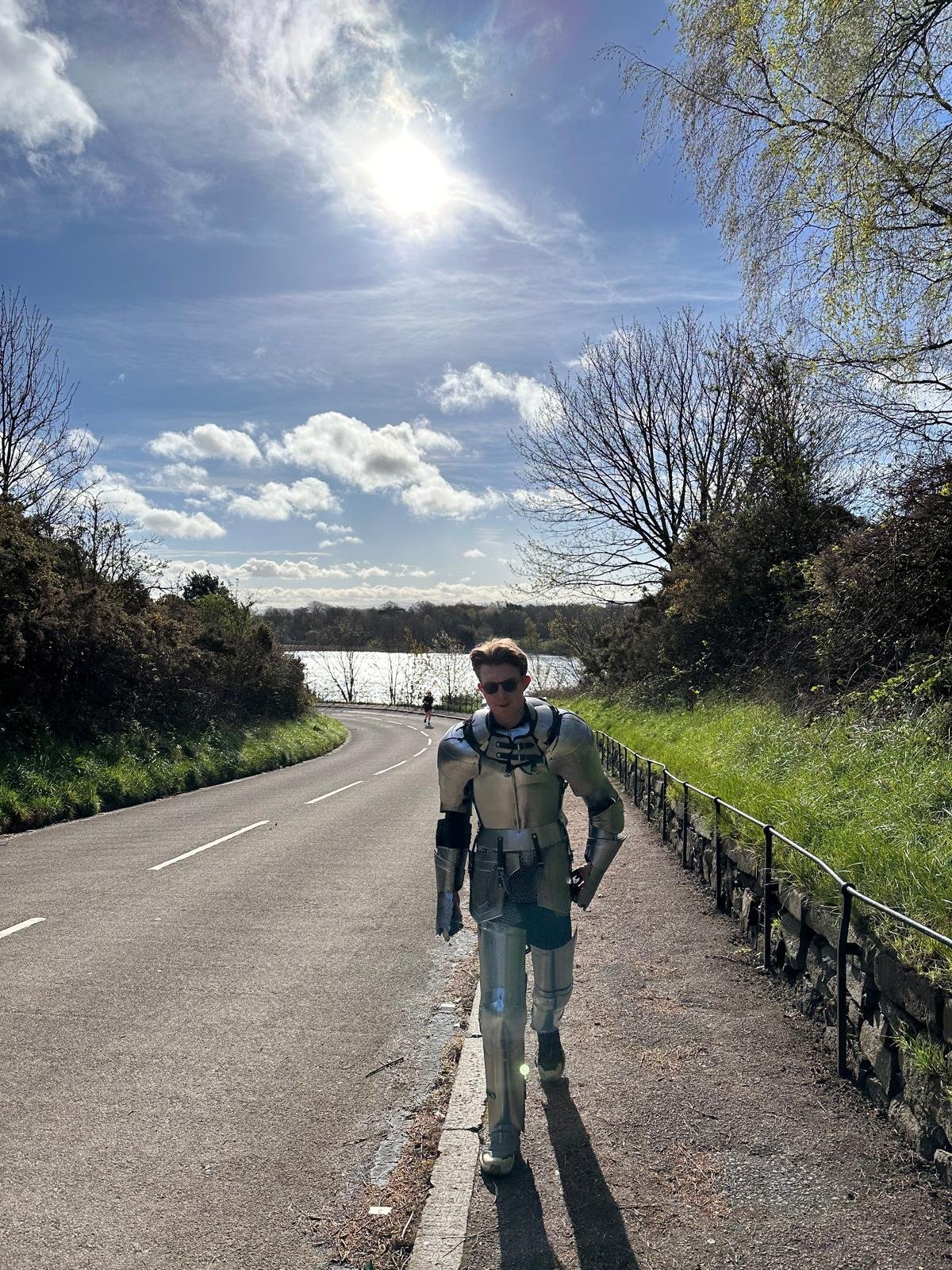 Andrew running in medieval armour near a loch